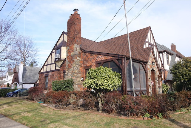 view of side of home with cooling unit and a yard