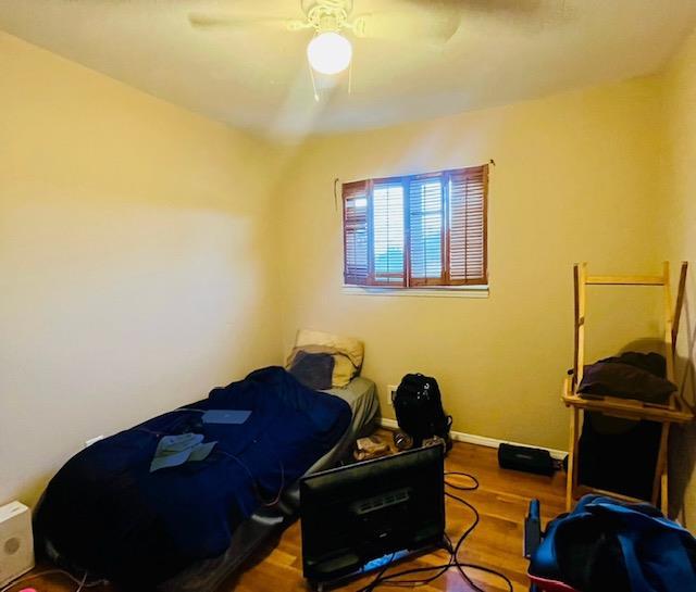 bedroom featuring hardwood / wood-style flooring and ceiling fan