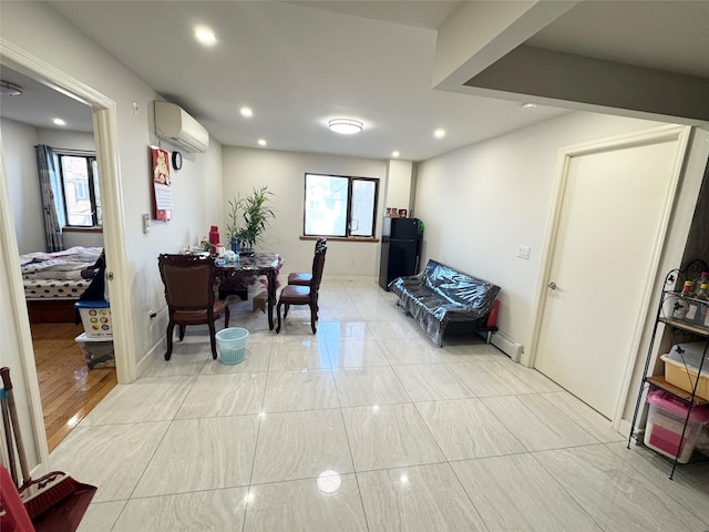 interior space with a baseboard radiator and a wall mounted air conditioner