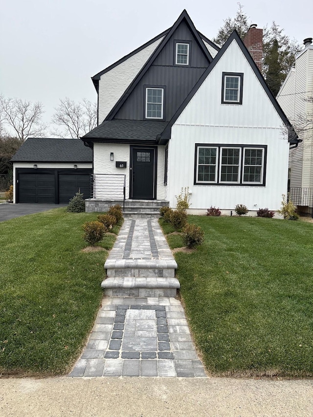 modern farmhouse featuring a garage and a front yard