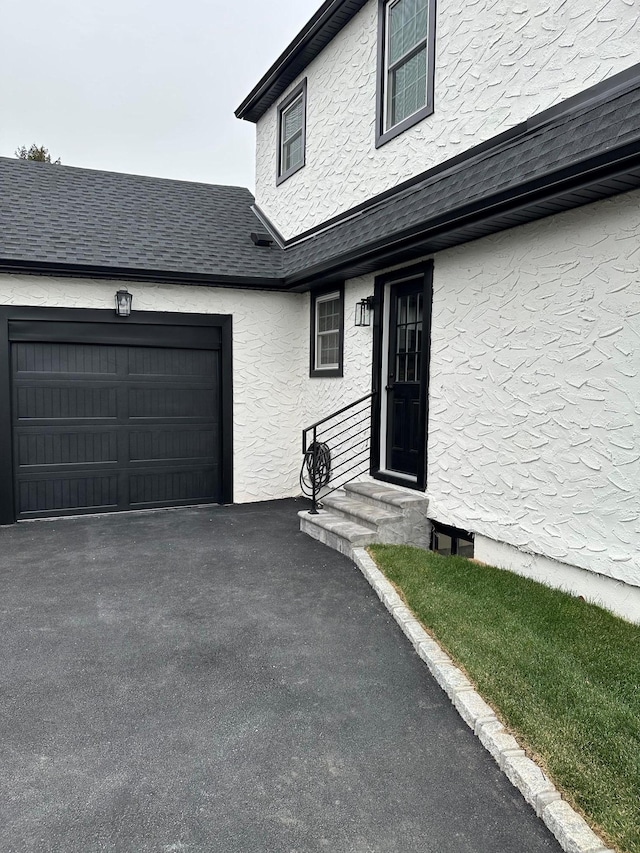 doorway to property with a garage