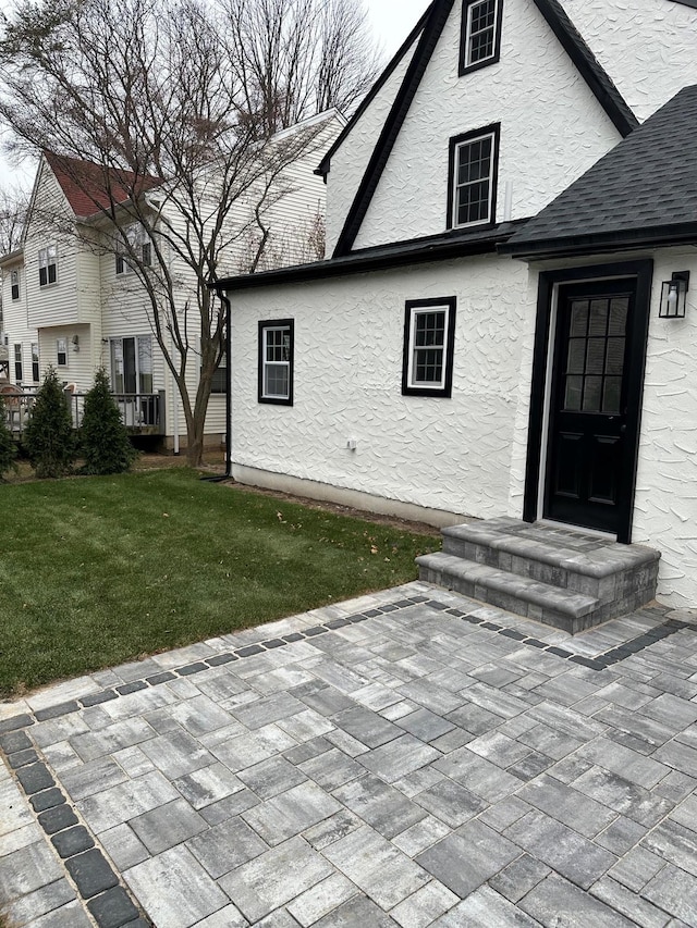 doorway to property with a yard