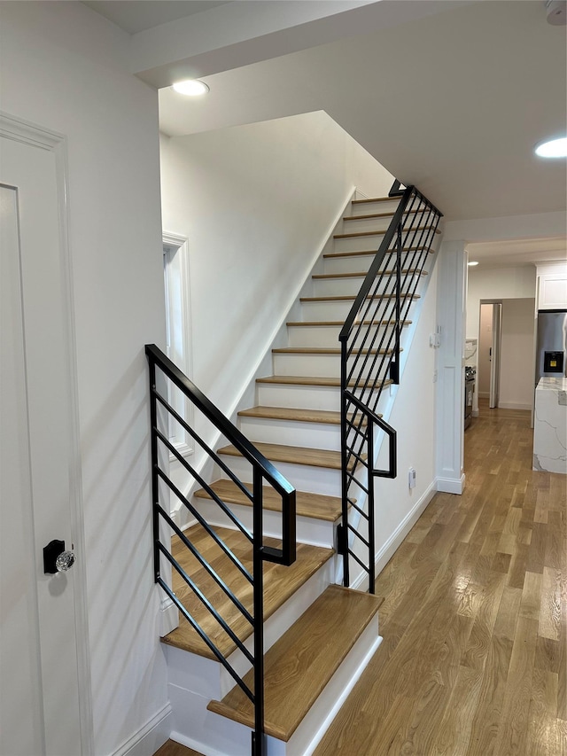 stairs featuring wood-type flooring