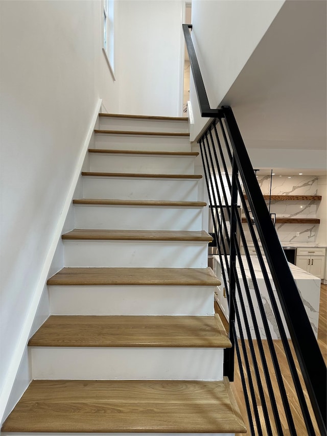 staircase featuring wood-type flooring