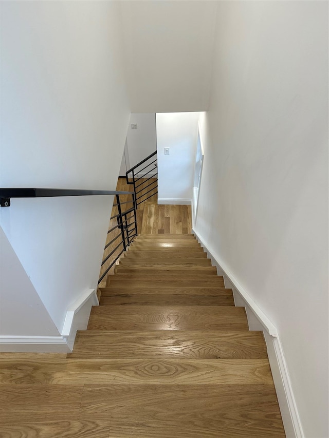 stairs with hardwood / wood-style flooring