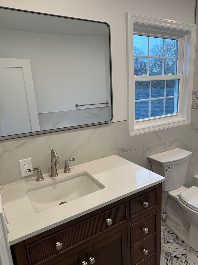 bathroom featuring backsplash, vanity, tile walls, and toilet