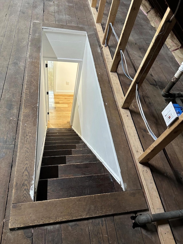 stairs featuring wood-type flooring