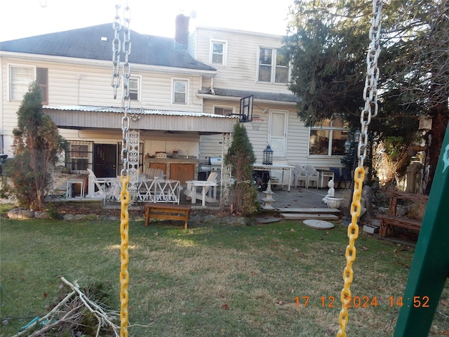 rear view of property with an outdoor bar, a deck, and a yard