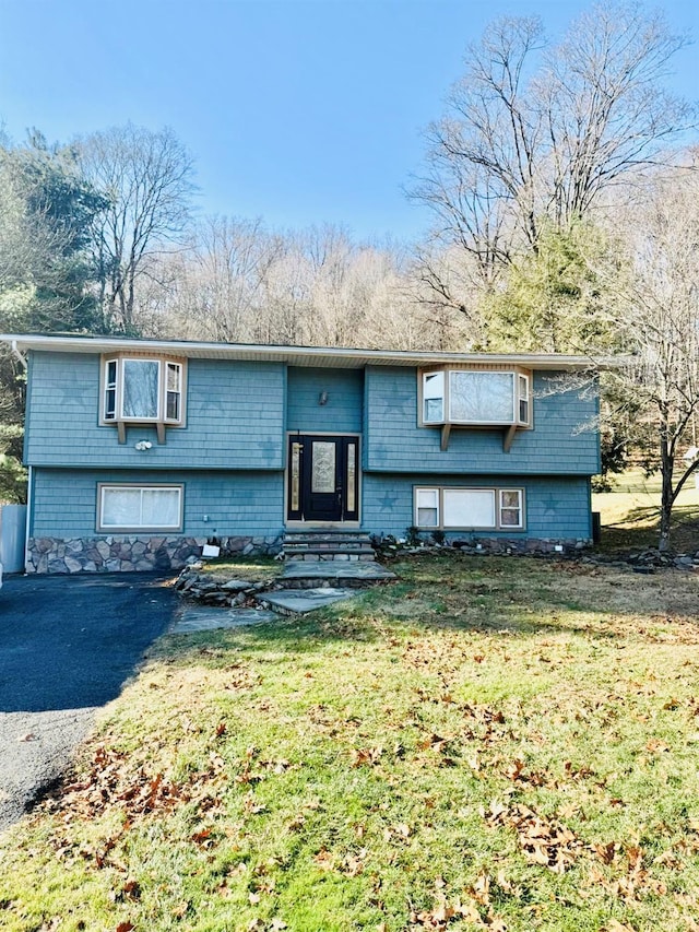 raised ranch with a front yard