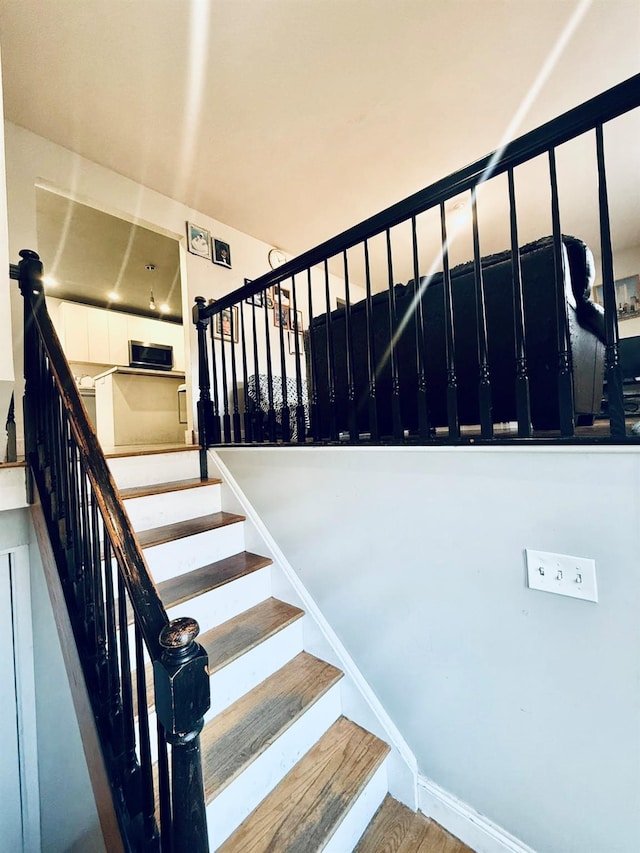 staircase with wood-type flooring