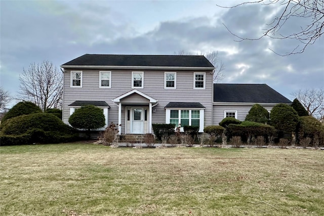 colonial home with a front lawn