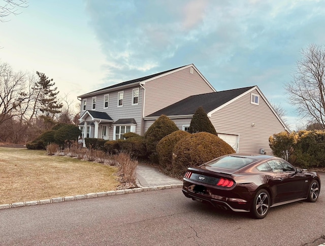 view of side of home with a lawn