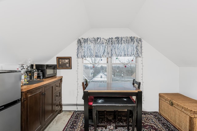 dining space with sink and vaulted ceiling