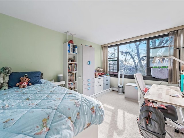 bedroom featuring light colored carpet and baseboard heating