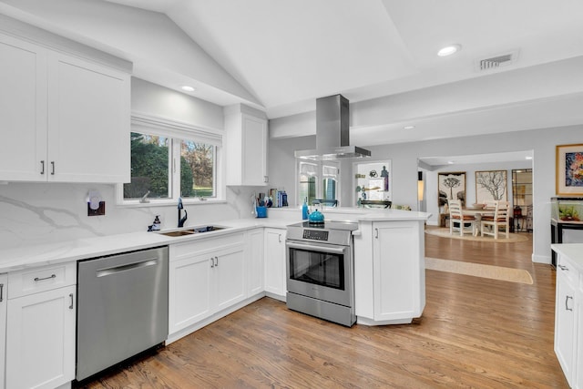 kitchen featuring decorative backsplash, appliances with stainless steel finishes, island range hood, sink, and white cabinets