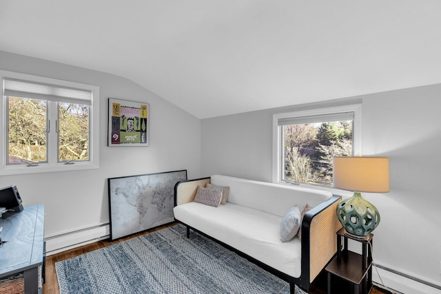 living area featuring vaulted ceiling, baseboard heating, and dark wood-type flooring