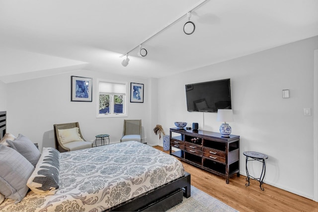 bedroom featuring light wood-type flooring and track lighting