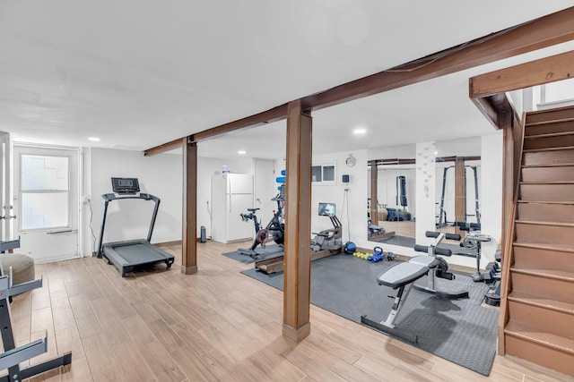 workout room featuring light wood-type flooring