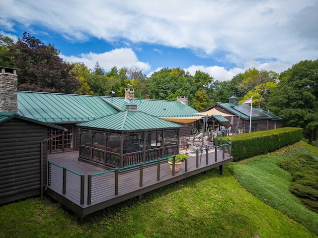 rear view of house with a gazebo and a wooden deck