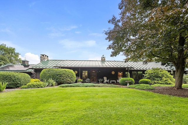 rear view of house with a lawn