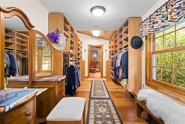 walk in closet featuring hardwood / wood-style flooring and vaulted ceiling