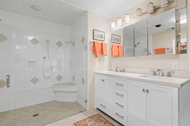 bathroom featuring a shower with door and vanity