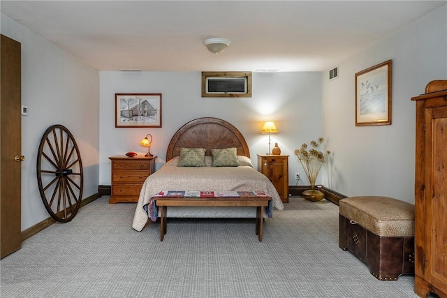 carpeted bedroom with a baseboard radiator