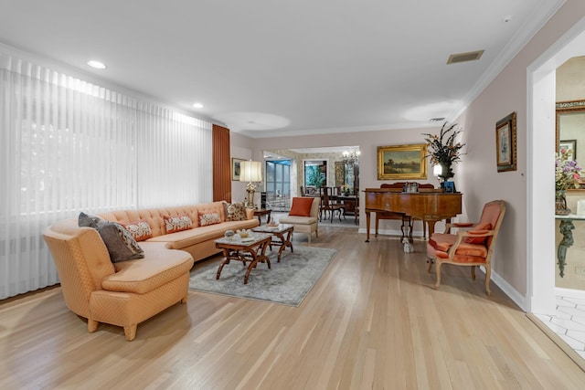 living room with light wood-type flooring and ornamental molding