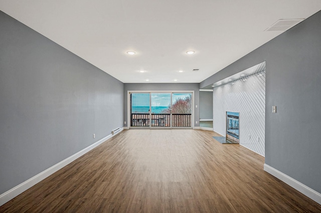 unfurnished living room featuring hardwood / wood-style flooring