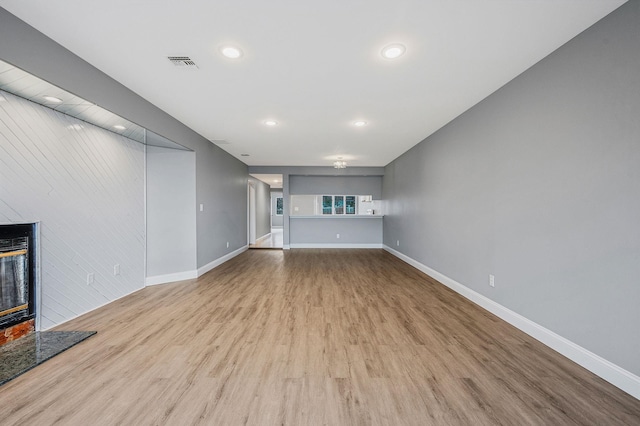 unfurnished living room with light hardwood / wood-style flooring