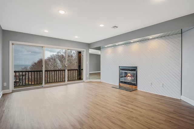 unfurnished living room with light wood-type flooring