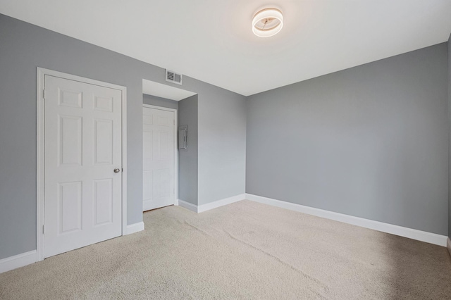 empty room with light colored carpet