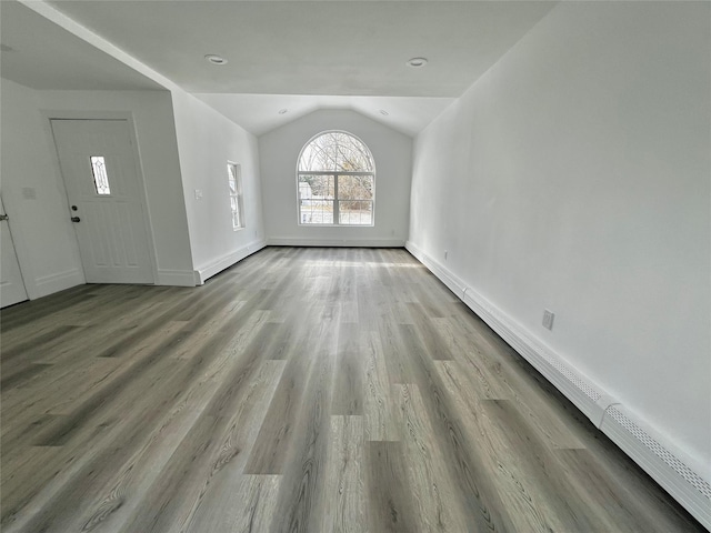 interior space featuring light hardwood / wood-style floors and vaulted ceiling