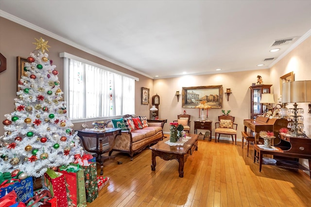 living room featuring light hardwood / wood-style flooring and ornamental molding