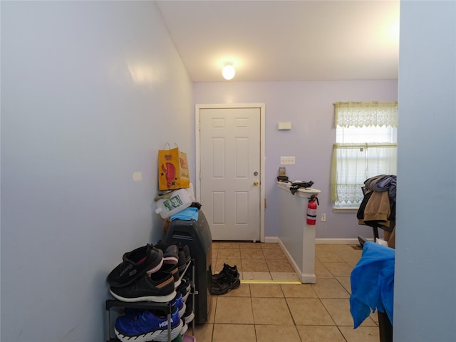 doorway featuring light tile patterned flooring