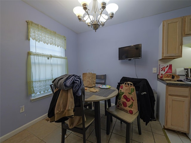 tiled dining space featuring a notable chandelier