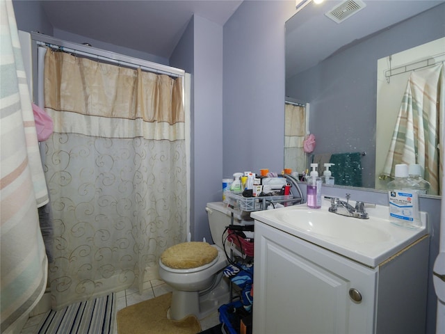 bathroom featuring tile patterned floors, vanity, and toilet