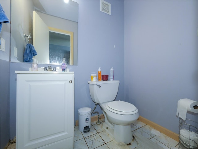 bathroom with tile patterned floors, vanity, and toilet