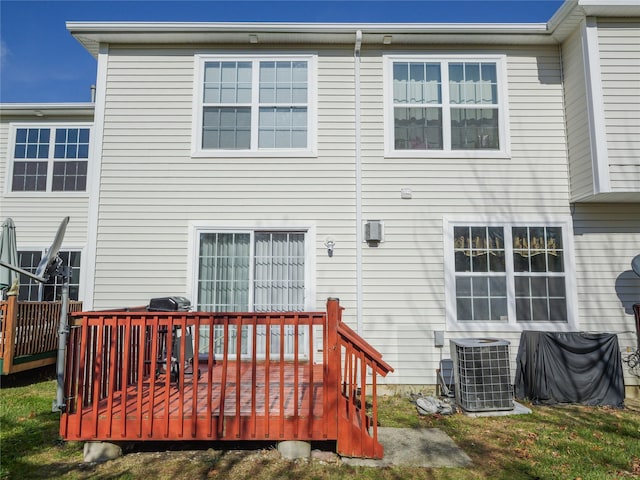 back of house featuring cooling unit and a deck