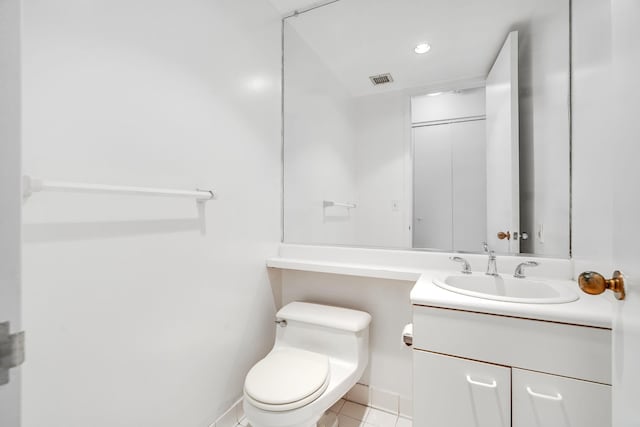 bathroom featuring vanity, toilet, and tile patterned flooring