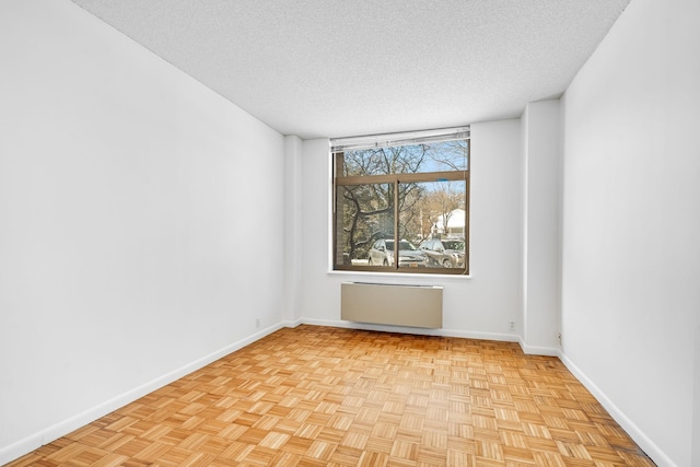 spare room with a textured ceiling