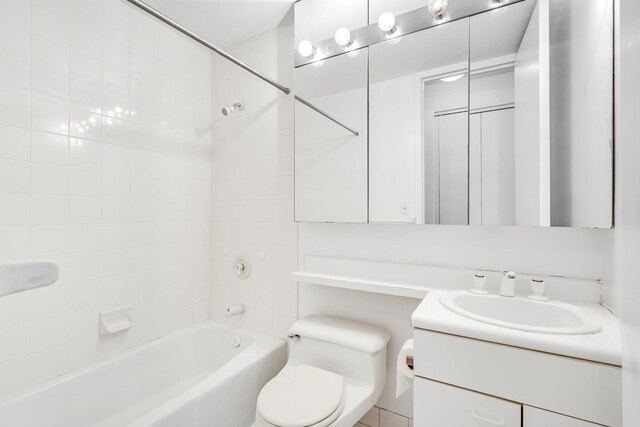 full bathroom featuring vanity, toilet, and  shower combination