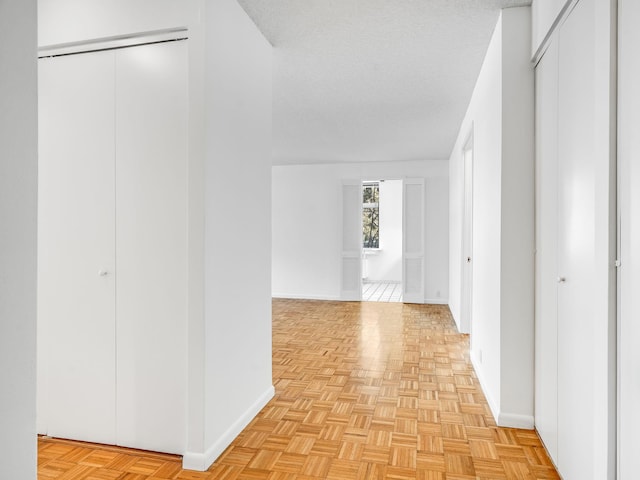 hall with a textured ceiling