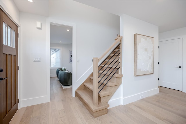 foyer entrance with light hardwood / wood-style floors