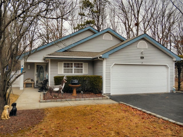 11 Westchester Ct, Middle Island, NY 11953 - view of front of house featuring aphalt driveway, roof with shingles, and a garage