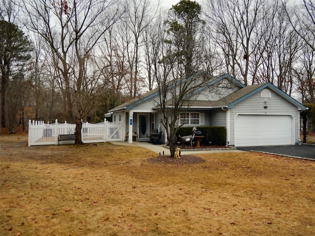 ranch-style home with aphalt driveway, a gate, fence, and a garage