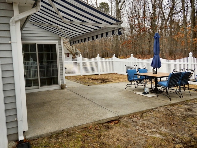 view of patio featuring a fenced backyard and outdoor dining area