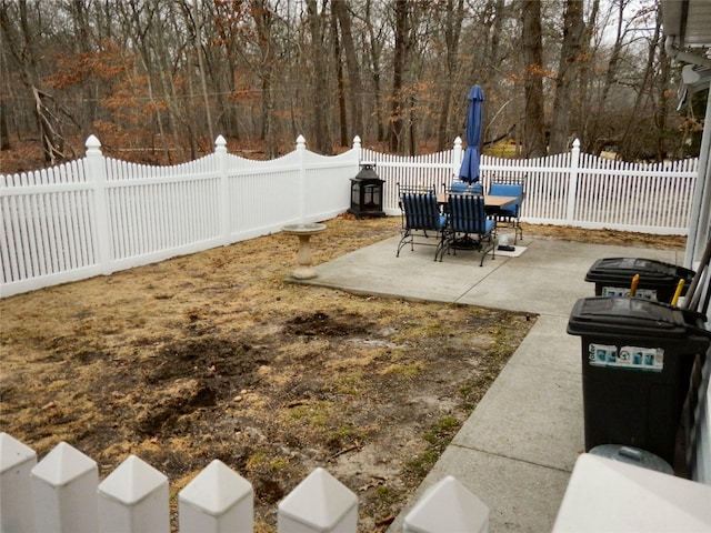 view of yard with outdoor dining area, a patio area, and a fenced backyard