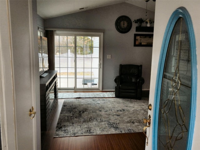 interior space featuring vaulted ceiling and wood finished floors