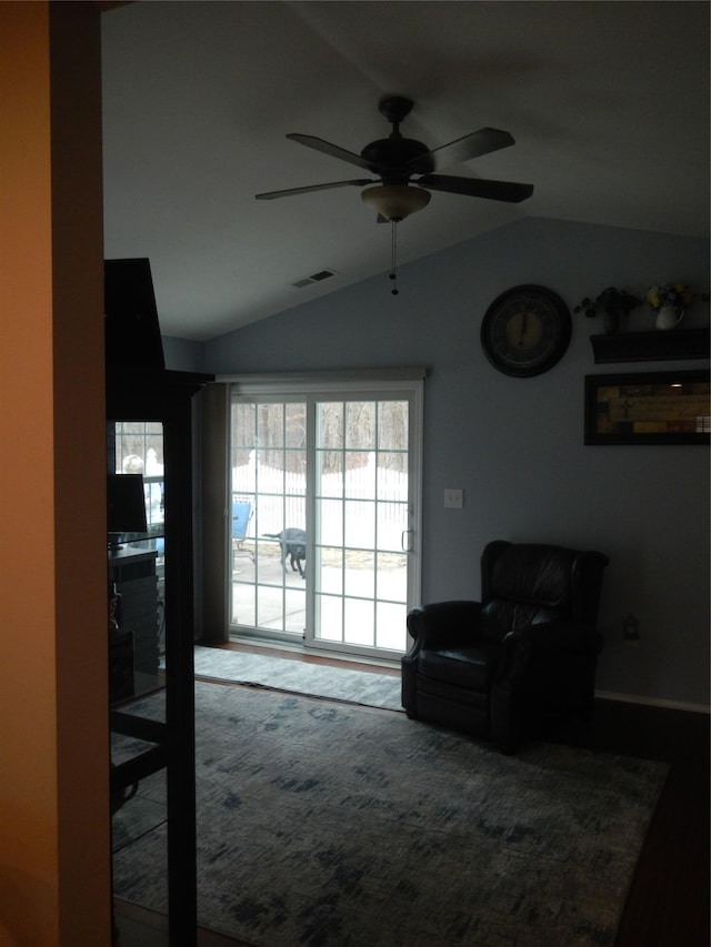 living area with lofted ceiling, ceiling fan, and visible vents